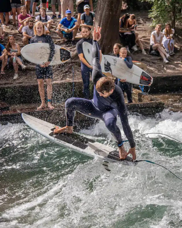 Sufers surfing on the Eisbach River in Munich