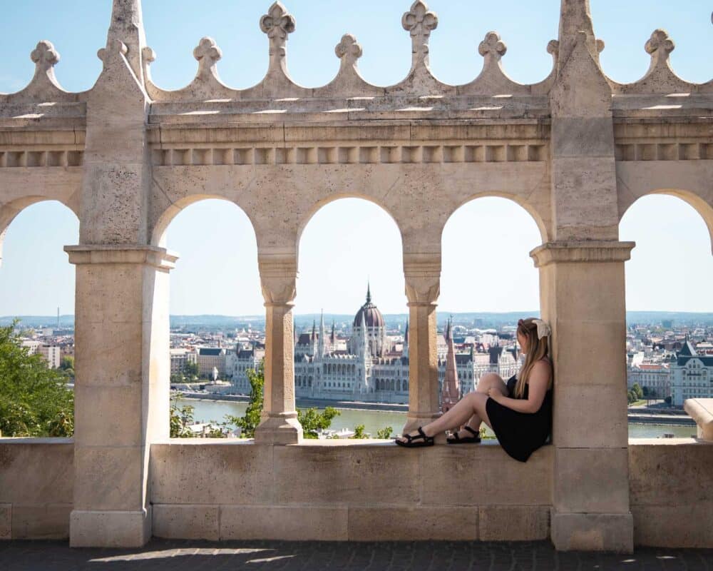 Girls sitting at fisherman's bastion in Budapest looking at the view